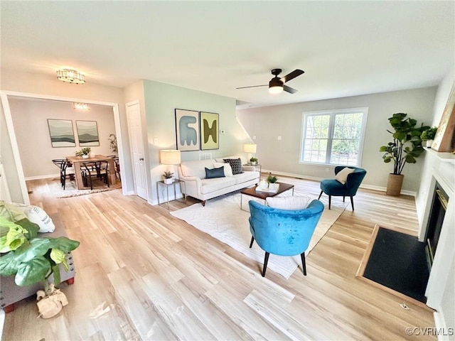 11809 Park Forest Ct, Henrico, VA 23059 - living area featuring light wood finished floors, a fireplace with flush hearth, and ceiling fan