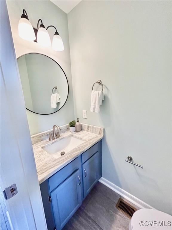 11809 Park Forest Ct, Henrico, VA 23059 - half bath featuring vanity and wood finished floors
