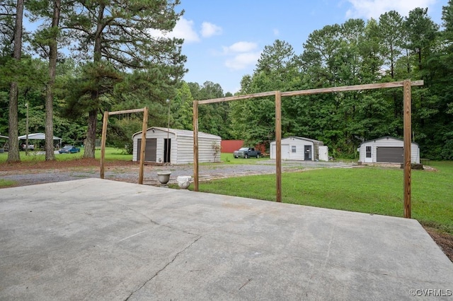 15116 Boydton Plank Rd, Dinwiddie, VA 23841 - view of patio with a storage unit and view of wooded area