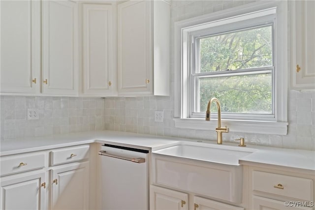 2301 Essex Rd, Henrico, VA 23228 - kitchen featuring light countertops, white cabinets, white dishwasher, and backsplash