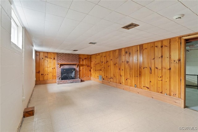 2301 Essex Rd, Henrico, VA 23228 - unfurnished living room featuring tile patterned floors, a fireplace, and wood walls