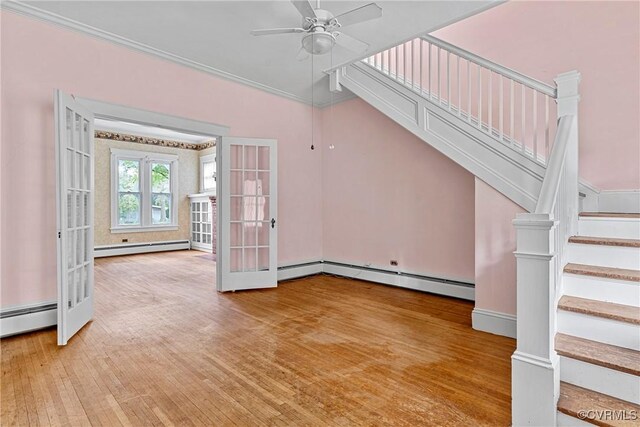 285 Jennings Ordinary Rd, Crewe, VA 23930 - unfurnished living room with a baseboard heating unit, ceiling fan, and stairs