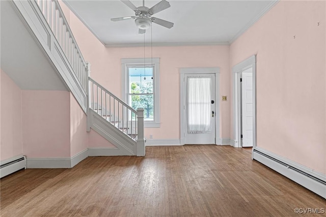 285 Jennings Ordinary Rd, Crewe, VA 23930 - entrance foyer featuring a baseboard heating unit, stairs, wood finished floors, a ceiling fan, and ornamental molding