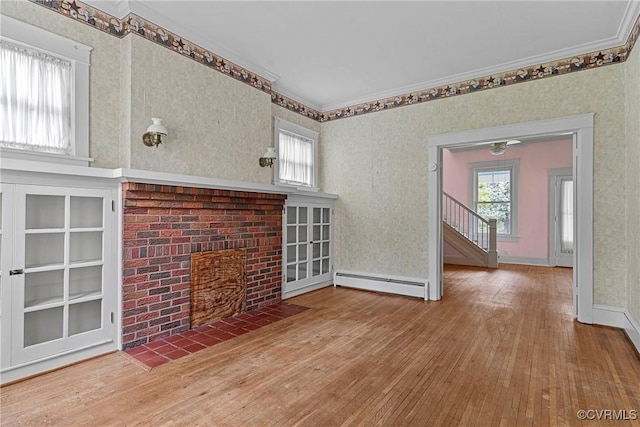 285 Jennings Ordinary Rd, Crewe, VA 23930 - unfurnished living room featuring a baseboard radiator, hardwood / wood-style floors, a fireplace, wallpapered walls, and crown molding