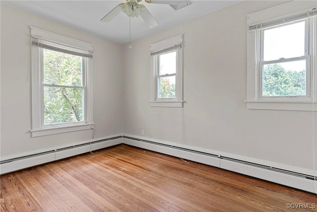 285 Jennings Ordinary Rd, Crewe, VA 23930 - empty room with healthy amount of natural light, a baseboard radiator, ceiling fan, and wood finished floors