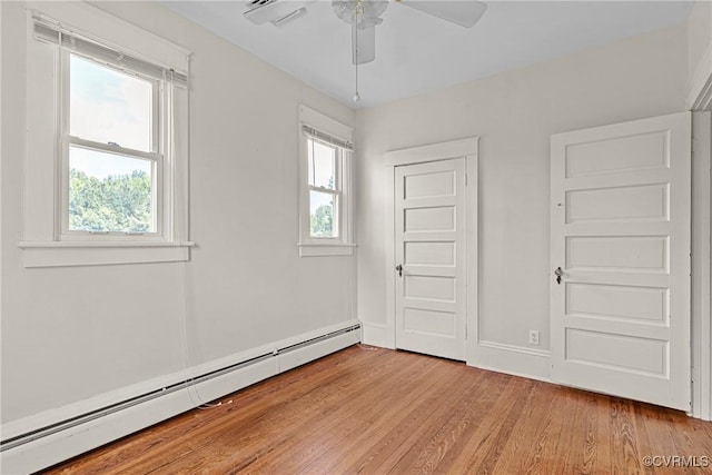 285 Jennings Ordinary Rd, Crewe, VA 23930 - unfurnished bedroom with a baseboard heating unit, light wood-type flooring, and a ceiling fan
