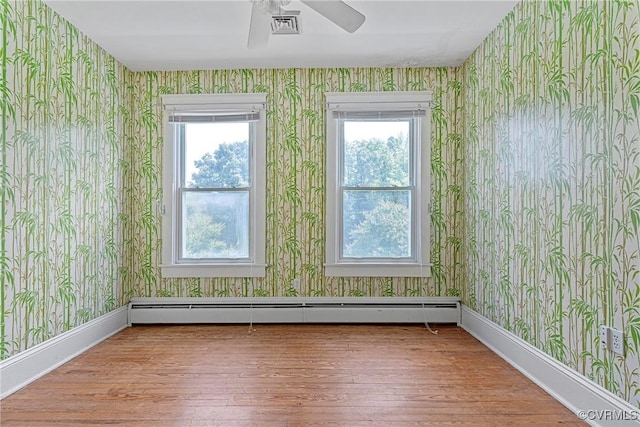 285 Jennings Ordinary Rd, Crewe, VA 23930 - unfurnished room with wallpapered walls, a baseboard heating unit, wood finished floors, and ceiling fan
