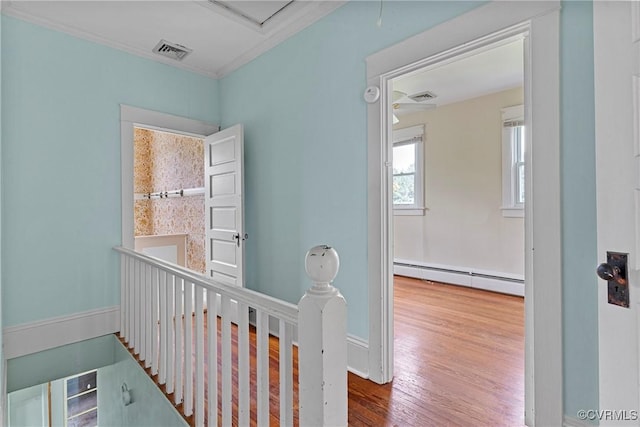 285 Jennings Ordinary Rd, Crewe, VA 23930 - hall with a baseboard heating unit, wood finished floors, an upstairs landing, and ornamental molding