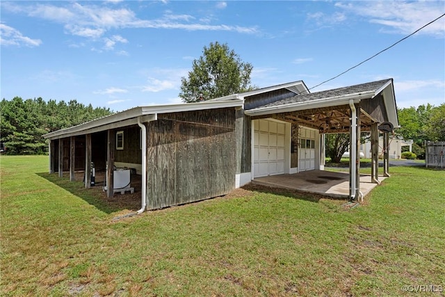 285 Jennings Ordinary Rd, Crewe, VA 23930 - back of property featuring a garage, a lawn, and a carport