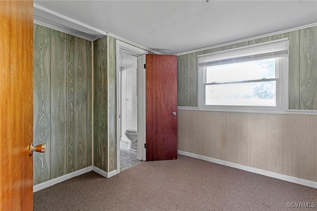 285 Jennings Ordinary Rd, Crewe, VA 23930 - unfurnished bedroom featuring carpet, wooden walls, and ensuite bathroom
