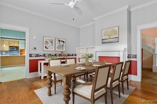 285 Jennings Ordinary Rd, Crewe, VA 23930 - dining room featuring light wood-style floors, crown molding, ceiling fan, and a fireplace