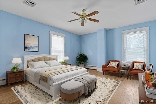 285 Jennings Ordinary Rd, Crewe, VA 23930 - bedroom featuring wood finished floors, a baseboard heating unit, and a ceiling fan