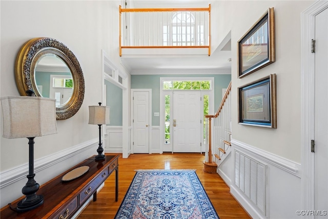 9929 Eildonway Pl, Henrico, VA 23238 - entrance foyer featuring healthy amount of natural light, wood finished floors, stairway, a towering ceiling, and ornamental molding
