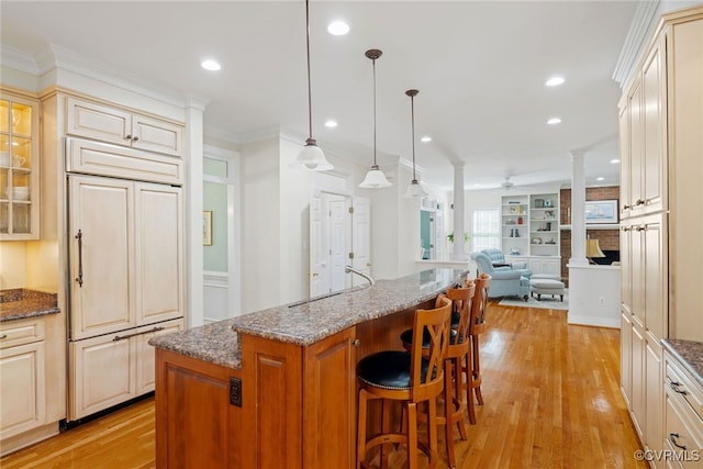 9929 Eildonway Pl, Henrico, VA 23238 - kitchen featuring paneled refrigerator, ceiling fan, a breakfast bar, light wood-style flooring, and dark stone countertops