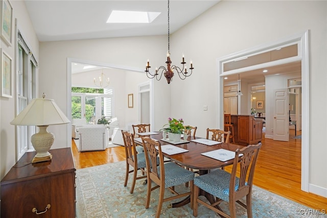 9929 Eildonway Pl, Henrico, VA 23238 - dining area with a chandelier, a skylight, vaulted ceiling, and light wood finished floors