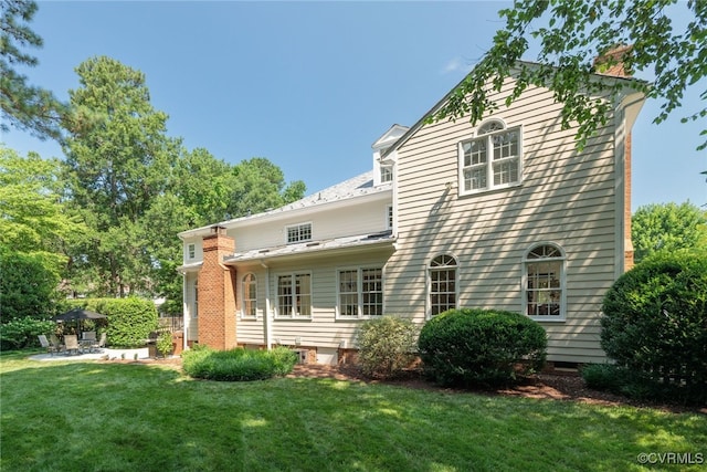 9929 Eildonway Pl, Henrico, VA 23238 - rear view of house with a chimney, a lawn, and a patio area