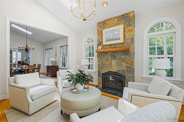 9929 Eildonway Pl, Henrico, VA 23238 - living area featuring a chandelier, wood finished floors, lofted ceiling, and a stone fireplace