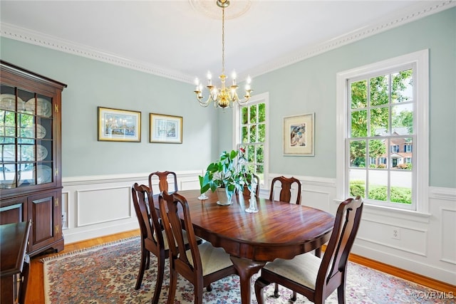 9929 Eildonway Pl, Henrico, VA 23238 - dining room with a chandelier, healthy amount of natural light, wood finished floors, wainscoting, and crown molding