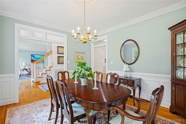 9929 Eildonway Pl, Henrico, VA 23238 - dining room with light wood-style flooring, stairway, a chandelier, a wainscoted wall, and ornamental molding