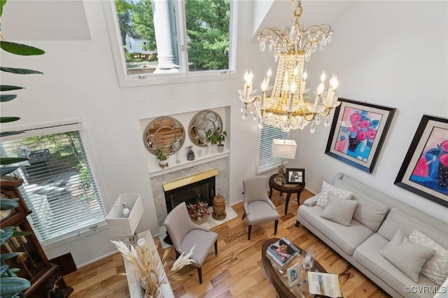 8256 Greystone W Cir, Henrico, VA 23229 - living room with a chandelier, wood finished floors, a towering ceiling, and a fireplace
