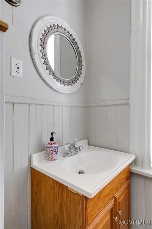 1320 W Main St, Richmond, VA 23220 - bathroom with vanity, wainscoting, and a decorative wall