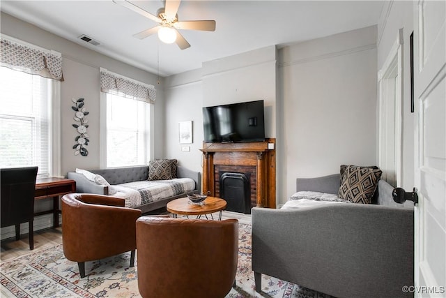 1320 W Main St, Richmond, VA 23220 - living area with ceiling fan, a brick fireplace, and light wood-style floors