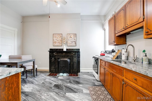1320 W Main St, Richmond, VA 23220 - kitchen with white electric range oven, a ceiling fan, brown cabinets, and a premium fireplace