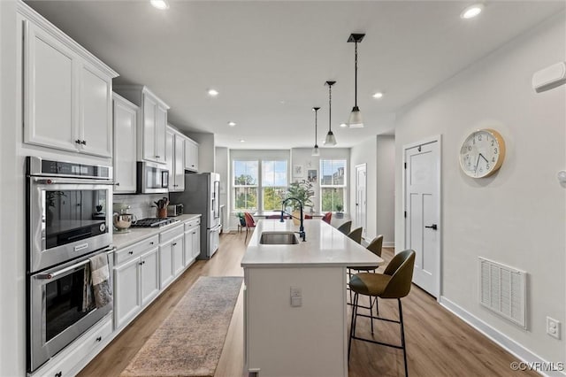 2133 Cantina Ln, Midlothian, VA 23114 - kitchen with appliances with stainless steel finishes, light wood finished floors, white cabinets, and recessed lighting