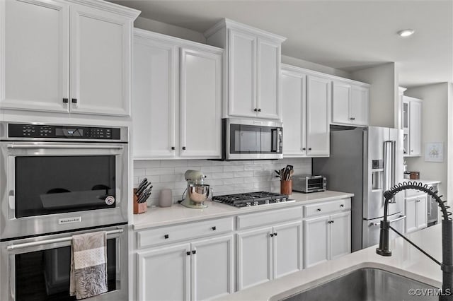 2133 Cantina Ln, Midlothian, VA 23114 - kitchen with stainless steel appliances, white cabinetry, and decorative backsplash