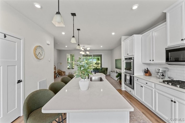 2133 Cantina Ln, Midlothian, VA 23114 - kitchen with stainless steel appliances, white cabinetry, tasteful backsplash, and recessed lighting