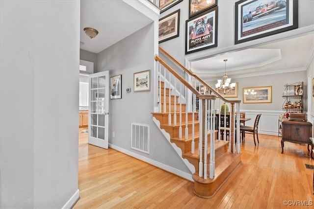 24000 Pear Orchard Rd, Moseley, VA 23120 - stairway with wood-type flooring, a chandelier, crown molding, and french doors