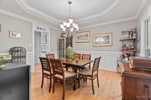 24000 Pear Orchard Rd, Moseley, VA 23120 - dining space featuring a raised ceiling, light wood-style floors, a chandelier, ornamental molding, and a wainscoted wall