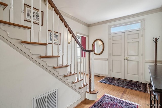 88 Holly Grv, Jamestown, VA 23185 - foyer with stairs, light wood-type flooring, and crown molding