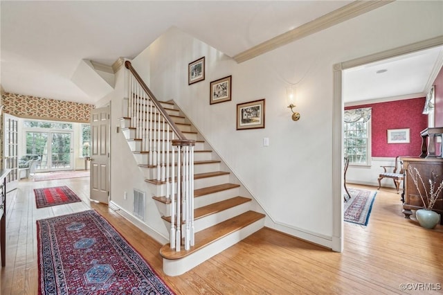 88 Holly Grv, Jamestown, VA 23185 - staircase featuring crown molding, hardwood / wood-style flooring, and plenty of natural light