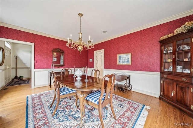 88 Holly Grv, Jamestown, VA 23185 - dining space featuring a wainscoted wall, a chandelier, light wood-type flooring, and crown molding