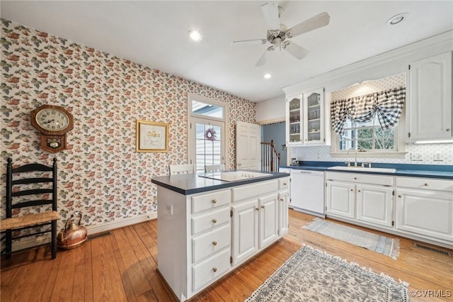 88 Holly Grv, Jamestown, VA 23185 - kitchen featuring wallpapered walls, dishwasher, dark countertops, ceiling fan, and white cabinetry