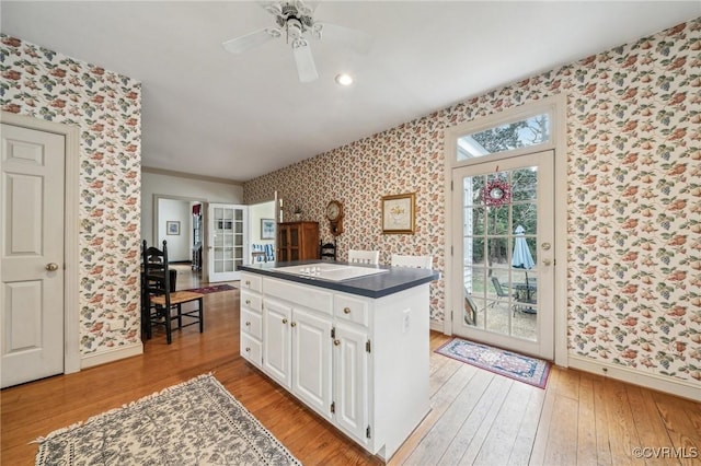 88 Holly Grv, Jamestown, VA 23185 - kitchen featuring wallpapered walls, dark countertops, light wood-style floors, white cabinetry, and a ceiling fan