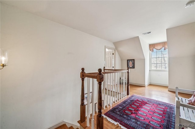 88 Holly Grv, Jamestown, VA 23185 - corridor featuring an upstairs landing, wood finished floors, and lofted ceiling