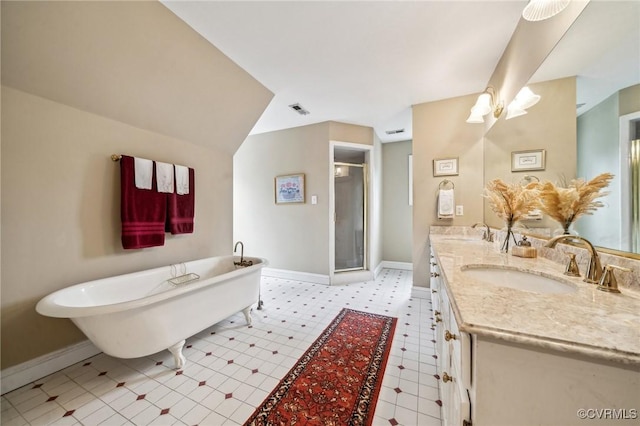88 Holly Grv, Jamestown, VA 23185 - bathroom with double vanity, a shower stall, a freestanding bath, and tile patterned floors