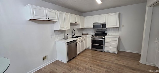 7464 Dutch Lily Ct, Mechanicsville, VA 23111 - kitchen with appliances with stainless steel finishes, tasteful backsplash, light wood-style floors, and light countertops