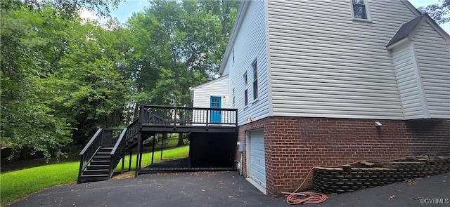7464 Dutch Lily Ct, Mechanicsville, VA 23111 - view of side of property featuring a garage, stairs, a deck, brick siding, and driveway