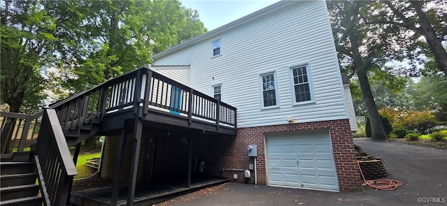7464 Dutch Lily Ct, Mechanicsville, VA 23111 - rear view of property featuring stairway, a deck, a garage, and asphalt driveway