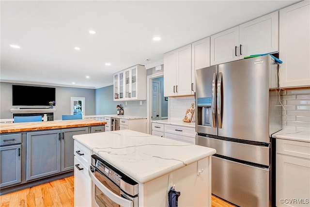 13904 Sunrise Bluff Rd, Chesterfield, VA 23112 - kitchen featuring appliances with stainless steel finishes, butcher block counters, glass insert cabinets, white cabinetry, and gray cabinets