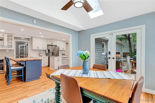 13904 Sunrise Bluff Rd, Chesterfield, VA 23112 - dining area with vaulted ceiling, light wood finished floors, ceiling fan, french doors, and a skylight