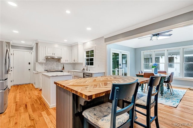 13904 Sunrise Bluff Rd, Chesterfield, VA 23112 - kitchen featuring a center island, white cabinets, crown molding, appliances with stainless steel finishes, and tasteful backsplash