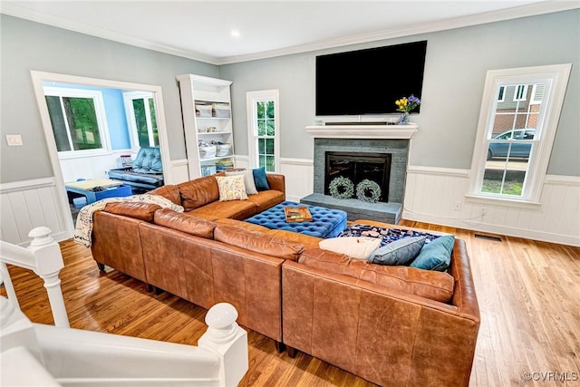 13904 Sunrise Bluff Rd, Chesterfield, VA 23112 - living area featuring a wainscoted wall, wood finished floors, ornamental molding, and a fireplace with raised hearth