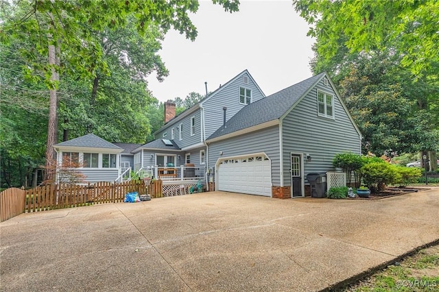 13904 Sunrise Bluff Rd, Chesterfield, VA 23112 - view of front facade with concrete driveway, a chimney, an attached garage, and a shingled roof