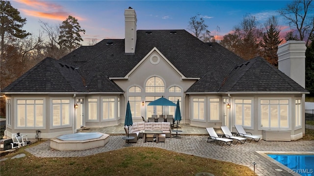 3808 Solebury Pl, Midlothian, VA 23113 - back of property at dusk featuring a chimney, a patio area, an outdoor living space, an outdoor pool, and stucco siding