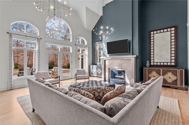3808 Solebury Pl, Midlothian, VA 23113 - living area featuring high vaulted ceiling, wood finished floors, a chandelier, and a tile fireplace