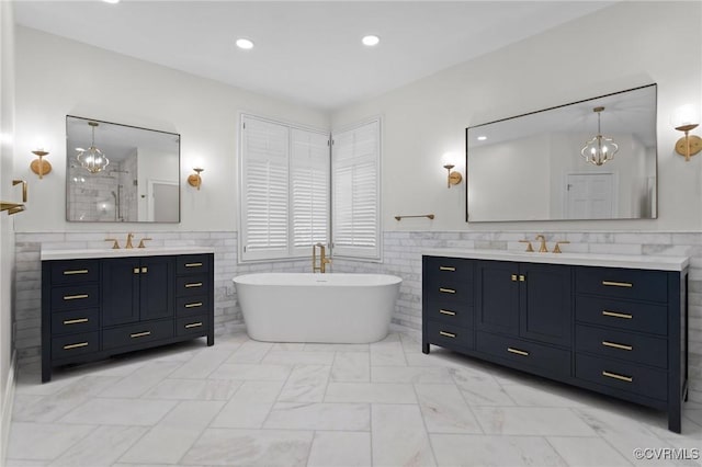3808 Solebury Pl, Midlothian, VA 23113 - bathroom with tile walls, two vanities, a soaking tub, wainscoting, and recessed lighting